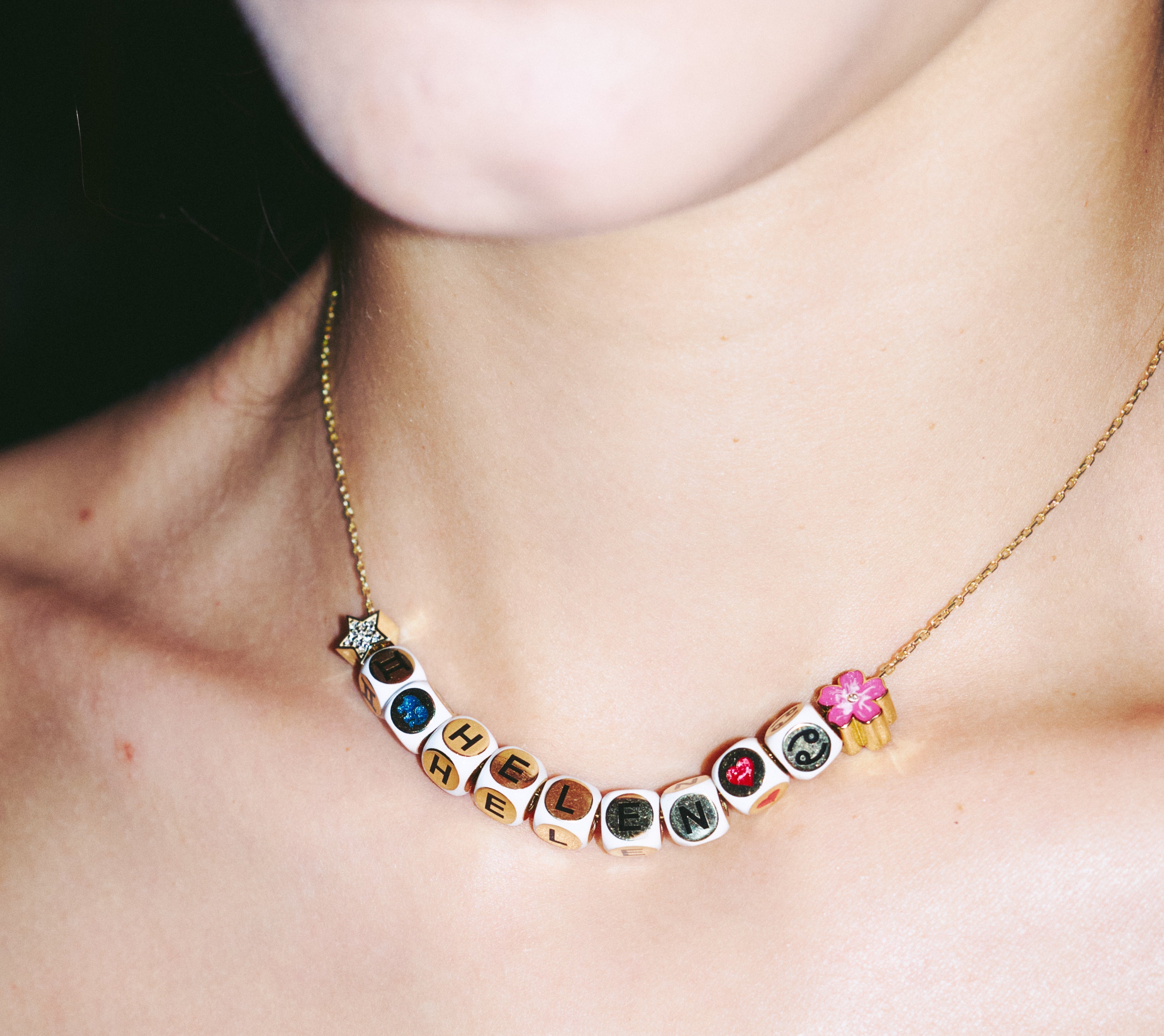 Necklace with colorful gemstones worn by a person