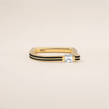 Gold ring with a diamond on a beige background