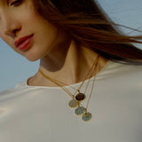 model wearing Rebel Jewelry 18k gold medallions 